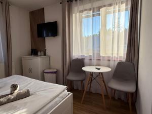 a bedroom with a bed and two chairs and a table at Rodzinna Ostoja in Zakopane +22 photos
