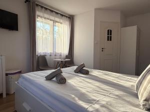 a bedroom with a large white bed with two pillows on it at Rodzinna Ostoja in Zakopane