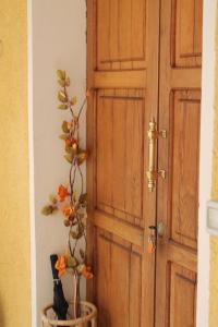 a wooden door with a vase with a plant in it at B&B Leonda in San Donato