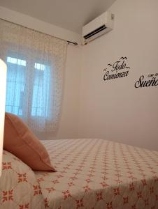 a bedroom with a bed with a quilt on it at Alojamiento Rural Los Jarritos in Galaroza +65 photos
