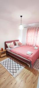 a bedroom with a bed with a pink blanket at Villa Ruscello in Grabovac