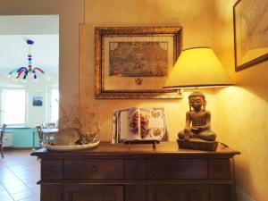 a table with a lamp and a statue on it at Locanda Miranda in Tellaro