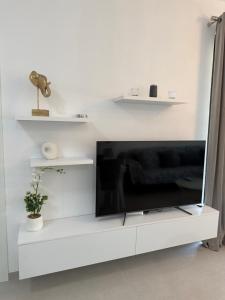 a flat screen tv sitting on a white entertainment center at Suar Apartment in Ksamil