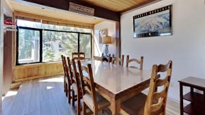 a dining room with a white table and chairs at Spacious 2 Bedroom Condo in Mammoth Lakes