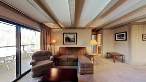 a living room with a couch and a table at Beautiful 2 BR Condo with Mountain View! in Mammoth Lakes
