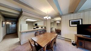 a kitchen and dining room with a table and chairs at Beautiful 2 BR Condo with Mountain View! in Mammoth Lakes +39 photos