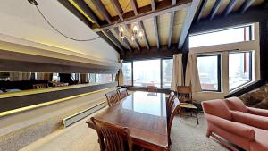 a dining room with a table and a couch at Cozy 4-Bedroom Home with Pool and Mountain View! in Mammoth Lakes