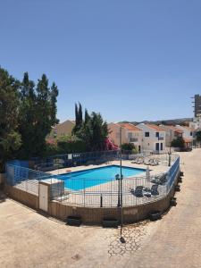 a large swimming pool with a fence around it at Morski zakątek 2 in Polis Chrysochous