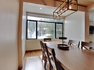 马姆莫斯湖1849 Condos 511 condo的一间有大木桌和椅子的餐厅