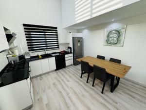 a kitchen and dining room with a table and chairs at Private Holiday Home in Kérynia