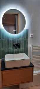 a bathroom with a sink and a mirror at Tiny House in Pontacq