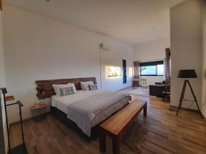 a bedroom with a large bed and a wooden floor at La Villa Des Oliviers chambres d hôtes in Petite Île +72 photos