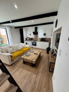 a living room with a couch and a table at La grange du bien-être in Liausson