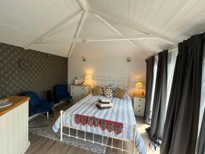 a bedroom with a white bed in a room at Stylish Cabin in East Sussex near Newhaven ferry in Newhaven