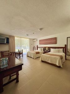 Postel nebo postele na pokoji v ubytování Hotel Nututun Palenque