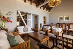 a living room with couches and a table at La Plage I Beachfront Villa on the Lagoon in Centre de Flacq
