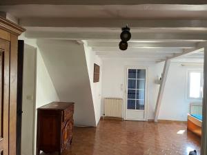 a hallway with a room with a chest and a window at Chambre in Sorbiers