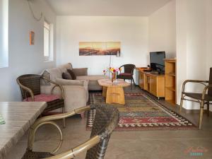 a living room with a couch and a table at Dubrava Rooms in Dobra Voda