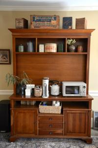 a wooden shelf with a microwave on top of it at Strasburg Village Inn in Strasburg +15 photos