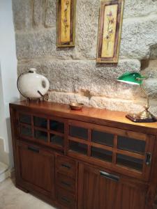 a wooden dresser with a lamp on top of it at Maradentro in Bueu +36 photos