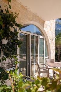 an open patio door with a table and chairs at Nova Studio Drymades in Dhërmi