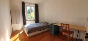 a bedroom with a bed and a desk and a chair at Maison à Die in Die