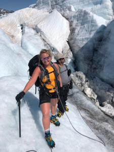 a couple of people walking on a glacier at Krossbu in Boverdalen
