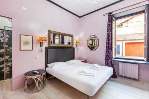 a bedroom with a large white bed and a window at La Meridiana d'Alba in Alba