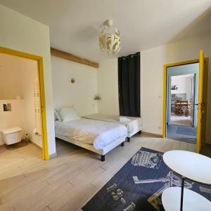 a bedroom with a bed and a table and a table at Gite La Lumette in Besse-et-Saint-Anastaise