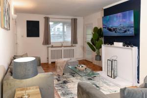 a living room with a couch and a table at Luxury Virginia Water 3BR near Thorpe Park & Heathrow in Virginia Water