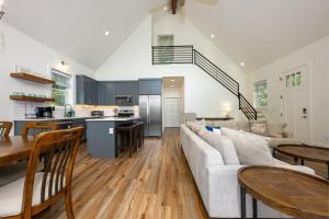 a kitchen and living room with a couch and a table at Unwind at Lakey McLakehouse on Lake Santeetlah in Robbinsville