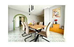 a dining room with a wooden table and chairs at Lovely Apartment In Katuni With Wifi in Katuni