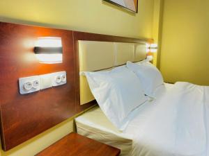 Letto o letti in una camera di Hotel Mirava