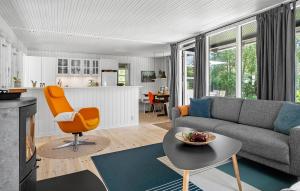 a living room with a couch and a table at 4 Bedroom Lovely Home In Mern in Mern