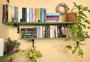 a book shelf on a wall with books at Skala Eresos Paradise Studios in Skala Eresou