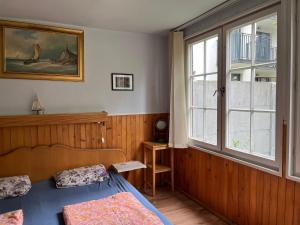 a bedroom with a bed and a window at Anker Kotwica in Łeba