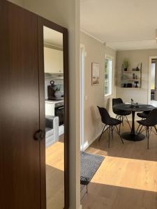 a kitchen and dining room with a table and chairs at Lakefront cabin on Skåne's largest island in Ivö