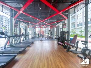 a gym with a bunch of treadmills and exercise bikes at 2BR Vibe Spot l Pool Access & Stunning City Views in Dubai