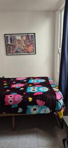a bedroom with a bed with a colorful blanket at Deptos Lago de Guadalupe in Mexico City +9 photos