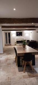 a living room with a table and a couch at Cottages Occitans in Villepinte