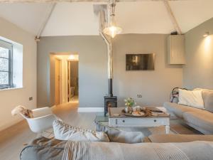 a living room with a couch and a table at Church Rooms in Northrepps