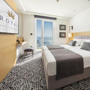 a hotel room with two beds and a window at Royal Neptun Hotel in Dubrovnik
