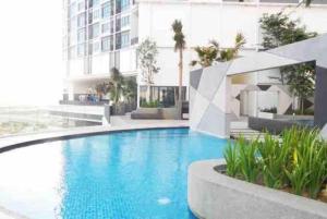 a large swimming pool in front of a building at I-City Homestay at Shah Alam by Landmark in Shah Alam