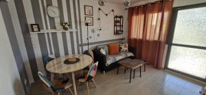 a living room with a table and a couch at Casa Marika in Costa Calma