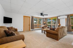 a living room with two couches and a tv at Fishing-Spider Lake-Pontoon Rental-Family Friendly in Traverse City