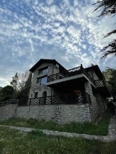a stone building with a balcony on a stone wall at Daphne Retreat in Kernitsa