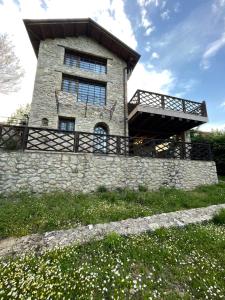 a building on top of a stone wall at Daphne Retreat in Kernitsa