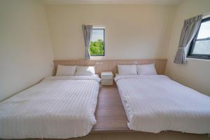 Krevet ili kreveti u jedinici u okviru objekta Xinghai Seaview Guesthouse