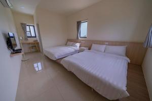 Krevet ili kreveti u jedinici u okviru objekta Xinghai Seaview Guesthouse