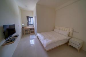 TV i/ili multimedijalni sistem u objektu Xinghai Seaview Guesthouse